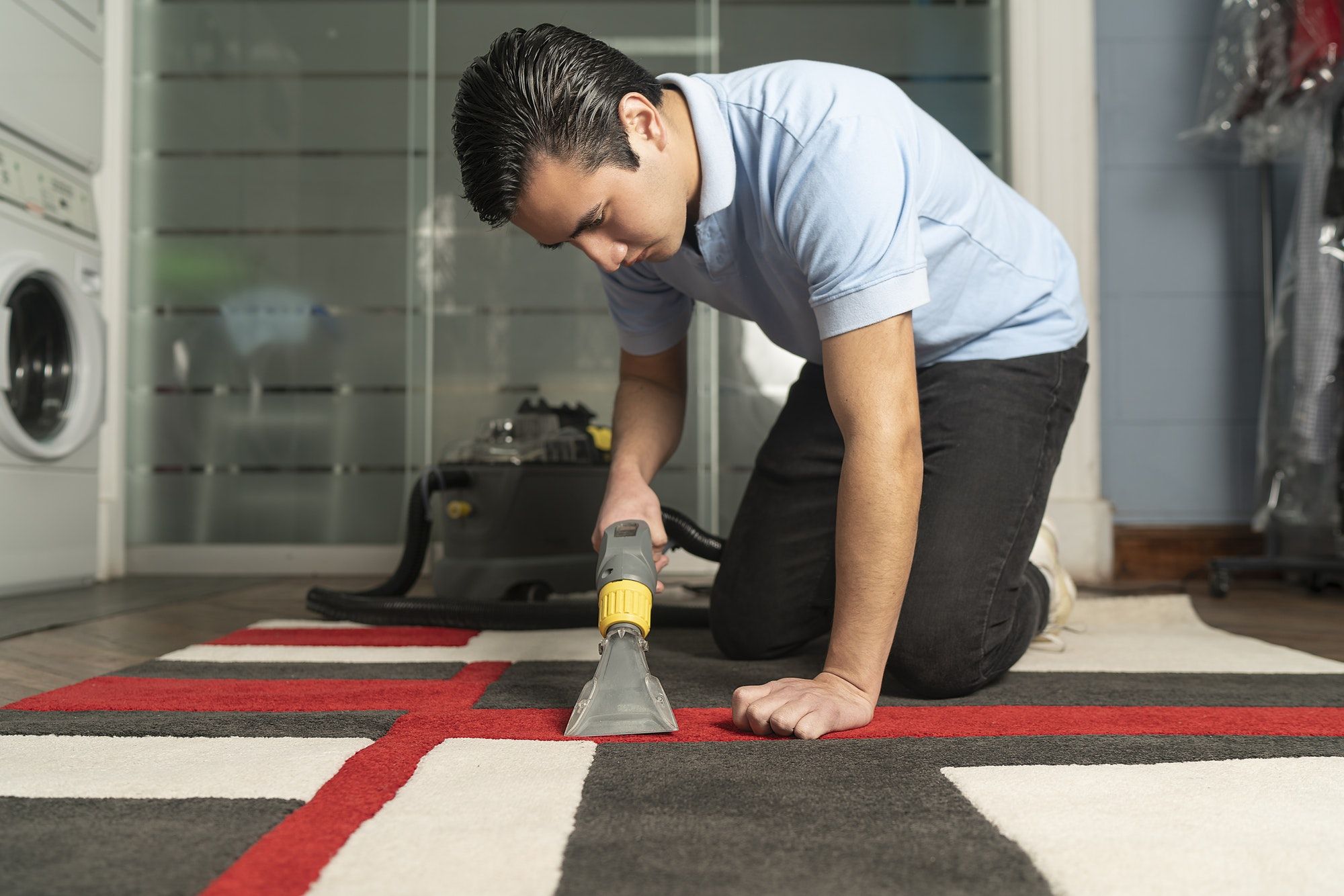 worker cleaning carpet with special equipment